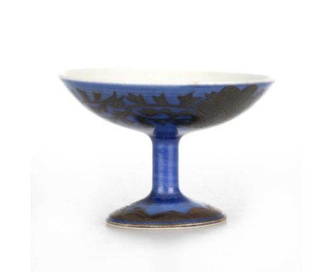 A CHINESE BLUE-GROUND PORCELAIN STEM DISH, BEARS KANGXI MARK the diminutive dish decorated with incised foliage around the un