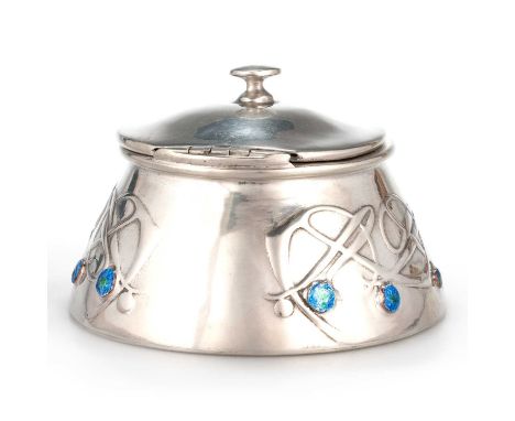 ARCHIBALD KNOX (1864-1933) FOR LIBERTY & CO, A TUDRIC PEWTER AND ENAMEL INKWELL the domed hinged cover with turned knop, the 