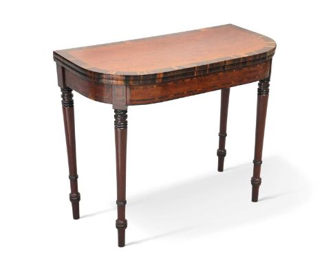 A REGENCY MAHOGANY AND COROMANDEL FOLDOVER CARD TABLE with a rounded rectangular top, raised on tapering turned legs. 75cm hi