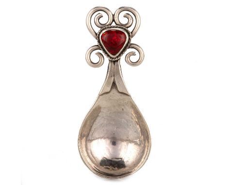 OMAR RAMSDEN: A GEORGE V SILVER AND ENAMEL CADDY SPOON London 1925, spot-hammered fig-shaped bowl, the tapering handle termin