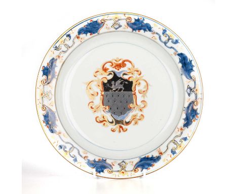 A CHINESE ARMORIAL PORCELAIN DISH, KANGXI, CIRCA 1720  circular, painted in an Imari palette with a European leaf scroll on t