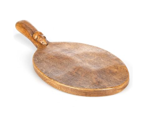 ROBERT THOMPSON OF KILBURN, A MOUSEMAN OAK CHEESEBOARD of oval form with a carved mouse signature on the base of the handle. 