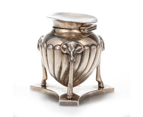 A VICTORIAN SILVER INKWELL by John Grinsell &amp; Sons, London 1895, the ovoid body decorated with reeding and raised on rams