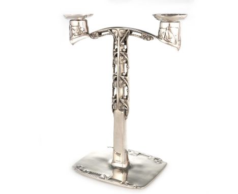 ARCHIBALD KNOX (1864-1933) FOR LIBERTY & CO, A TUDRIC PEWTER CANDELABRUM with twin-branches supported on a column with openwo