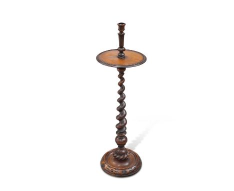 A 19TH CENTURY WALNUT CANDLESTAND with dished circular shelf above a boldly turned barley twist stem issuing from a dished ci