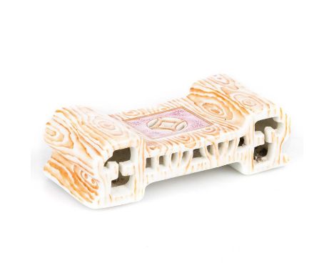 A CHINESE FAUX BOIS AND PUCE ENAMEL RETICULATED BRUSH REST of shaped, stepped outline, the reverse with a six-character Qianl