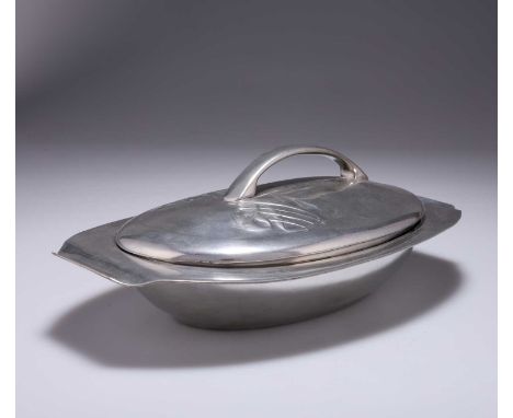 ARCHIBALD KNOX (1864-1933) FOR LIBERTY & CO, A TUDRIC PEWTER MUFFIN DISH no. 0295, oval-shaped, the lift-off lidded cover dec