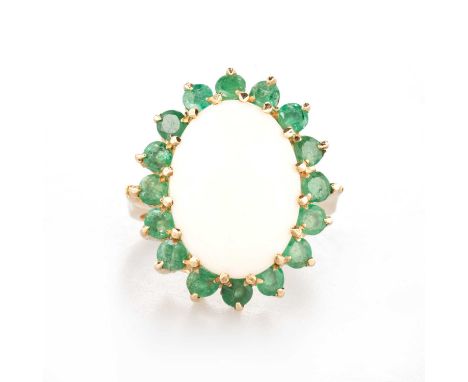 A 9 CARAT GOLD OPAL AND EMERALD CLUSTER RING an oval opal within a border of round-cut emeralds. Hallmarked Birmingham 1975, 