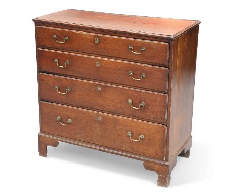 A GEORGE III OAK CHEST OF DRAWERS the rectangular top with molded edge, above four long graduated drawers, each fitted with b