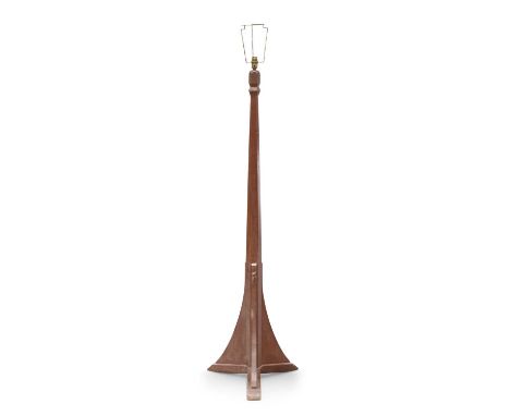 ATTRIBUTED TO HERBERT BIRD OF YORK, A KINGFISHERMAN OAK STANDARD LAMP the tapering faceted stem raised on a tri-form base, wi
