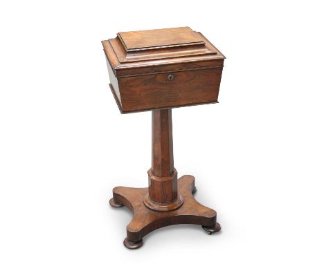 A REGENCY ROSEWOOD TEAPOY the caddy of sarcophagus form the hinged cover opening to reveal two pairs of cannisters and two va