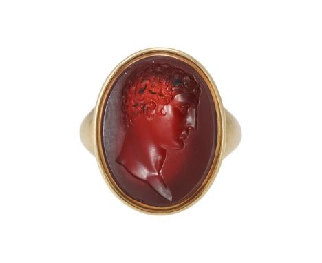 AN EARLY 18TH CENTURY CORNELIAN INTAGLIO RING The oval cornelian panel carved with the profile of a youth, possibly Adonis or