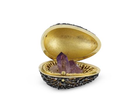 A SILVER GILT SURPRISE EGG STUART DEVLIN, LONDON 1968 The textured and bark effect body opening to an amethyst quartz 7.5cm (