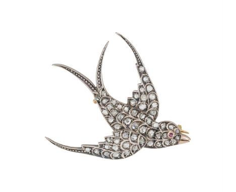 AN EARLY 20TH CENTURY DIAMOND SET SWALLOW BROOCH  The gold backed silver swallow in flight set throughout with rose cut diamo