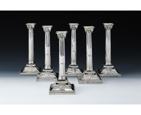 A SET OF SIX VICTORIAN SILVER CANDLESTICKS FAVELL, ELLIOTT & CO., LONDON 1888 The sconces with beaded borders, the scrolled c