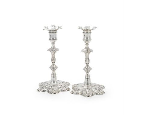 A PAIR OF GEORGE II CAST SILVER CANDLESTICKS JOHN CAFE, LONDON 1751 With shaped circular sconces, reel capitals, knopped balu