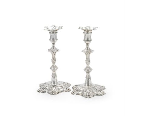 A PAIR OF GEORGE II CAST SILVER CANDLESTICKS JOHN CAFE, LONDON 1751 With shaped circular sconces, reel capitals, knopped balu