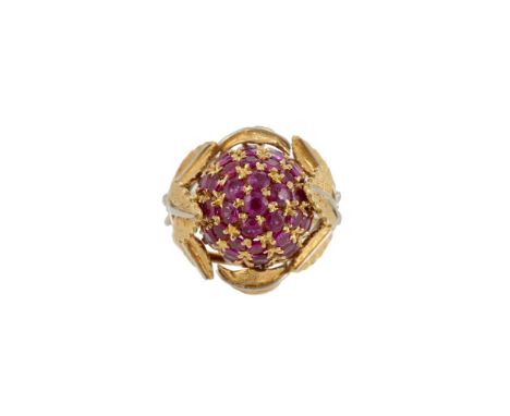 A 1960S RUBY AND 18 CARAT GOLD BERRY RING  The pavé set circular cut ruby bombé berry within two colour textured trefoil leaf