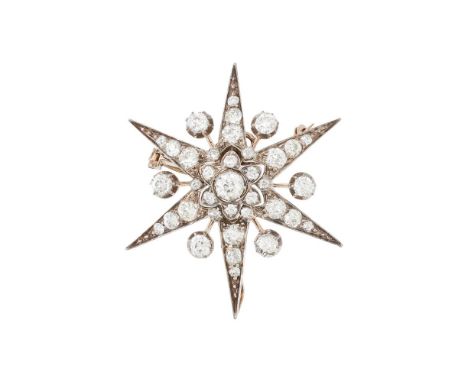 A DIAMOND STAR BROOCH  The six point star set with old European cut diamonds, with diamond accents on knife edge bars between