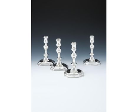 A MATCHED SET OF FOUR QUEEN ANNE AND GEORGE I SILVER OCTAGONAL CANDLESTICKS ANTHONY NELME, LONDON 1713 (2) AND 1714 (2) With 