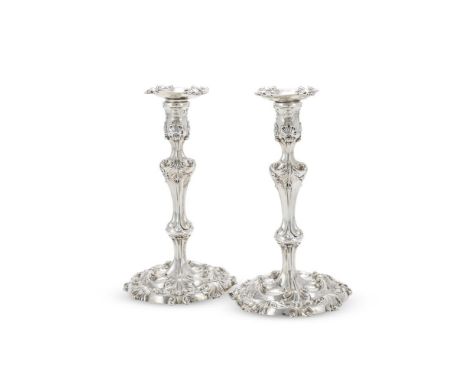 A PAIR OF GEORGE II SILVER CANDLESTICKS WILLIAM SKEEN, LONDON 1755 The sconces with shells to the corners, baluster capitals,