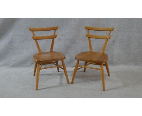 A pair of mid century vintage Ercol light elm and beech red dot child's chairs. H.59cm 