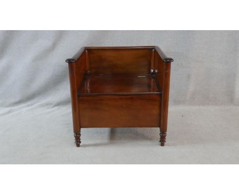 A 19th century Continental mahogany commode with lift up seat on turned supports. H.70 W.76 D.59cm 