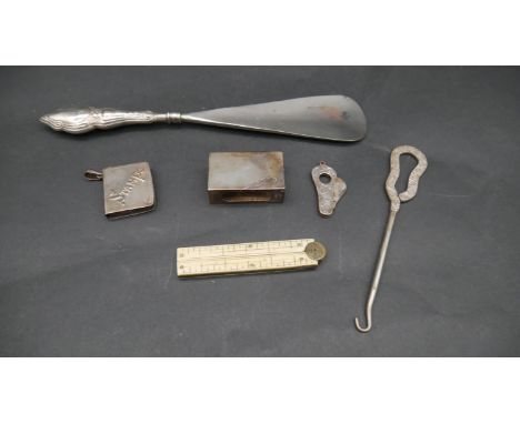 A collection of silver items. Including a silver handled shoe horn, an ivory and brass measure with concealed pen knife, a en