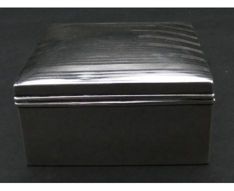 A cedar lined silver cigarette box with linear engine turned decoration. Hallmarked: AZ for A &amp; J Zimmerman Ltd, Birmingh