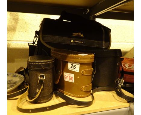Three pairs of binoculars and a cine camera in a bag