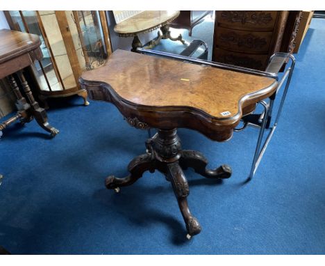 A Victorian walnut fold over card table with serpentine and moulded edge, supported on quadruple legs, 96cm W