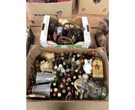 Two boxes of whisky and alcohol miniatures, tankards, ornamental cannon bookends and a Courvoisier Cognac bottle on wagon