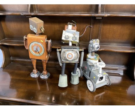 Three bespoke hand crafted robot sculptures constructed from recycled material, the largest measures 53cm H