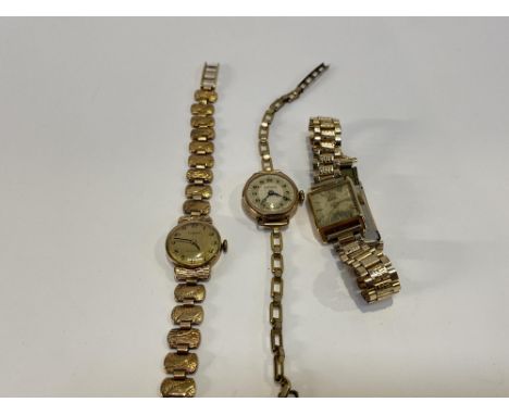 A yellow metal Art Deco cocktail watch by Claridge and two other cocktail watches