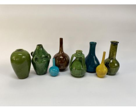 An early 20th Century Continental three handled vase, covered in a green glaze, 18cm H, together with seven other glazed pott