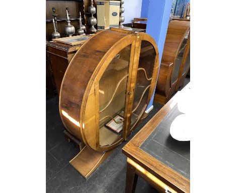 An Art Deco walnut spherical china cabinet