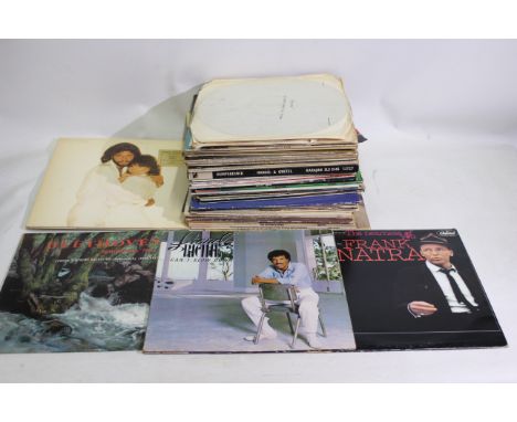 Vinyl Records - A collection of 12" vinyl records to include Lionel Richie, Frank Sinatra, Beethoven, Barbra Streisand and Ba