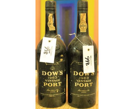 Two bottles of Dow's 1963 vintage port. (2) CONDITION REPORT: Labels a little chipped with minor losses, bottles a little gru