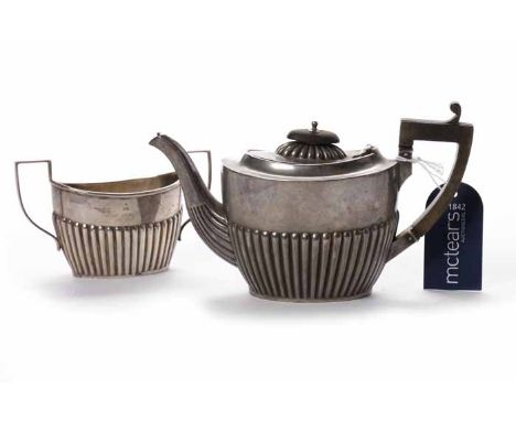 EDWARDIAN SILVER BACHELOR'S TEAPOT AND SUGAR BOWL
maker J Sherwood & Sons, Birmingham 1908, of partially gadrooned oval form,