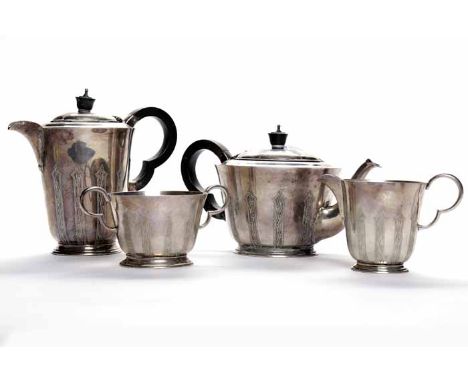 SILVER FOUR PIECE TEA SERVICE
maker Wakely & Wheeler, London 1939, of circular form engraved with repeating stylised branch d