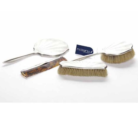 GEORGE V SILVER FOUR PIECE VANITY SET
maker Elkington & Co Ltd, Birmingham 1928, comprising a hand mirror, a hair brush, a cl