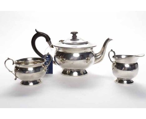 GEORGE V SILVER THREE PIECE TEA SERVICE
maker's mark 'F. Ltd', Birmingham 1932, of squat round form with scroll handles, appr