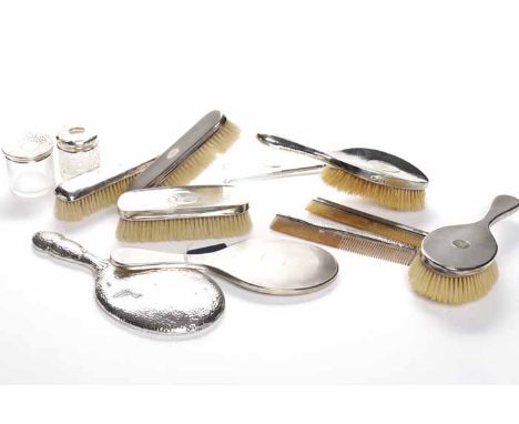 ELEVEN EARLY 20TH CENTURY SILVER DRESSING TABLE ITEMS
including a George V four piece silver vanity set, maker James Dixon & 