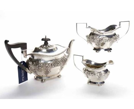 EDWARDIAN SILVER THREE PIECE BACHELOR'S TEA SERVICE
maker Walker & Hall, Sheffield 1902, of lobed oval form, embossed with fl