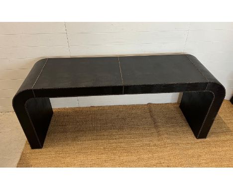 A console table with stud detail and faux leather (H75cm W180cm D51cm)