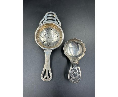 A silver tea strainer, hallmarked Birmingham 1932 by Angora Silver Plate Co Ltd along with a caddy spoon by Oliver & Bower Lt