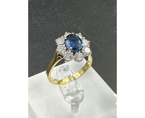 A sapphire and diamond cluster ring  on an 18ct (750) shank.