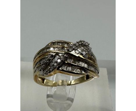 A 9ct yellow gold and diamond cross over ring with baguette style setting Size L