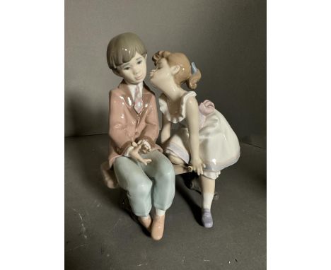 Two boxed Lladro figures, a lady with parasol and a boy and girl on bench Condition Report good condition&nbsp;