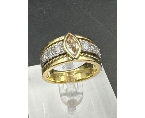 A yellow gold diamond ring with central stone and three separate diamonds to each side .Size Q